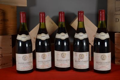 six bottles of wine are lined up on a red table