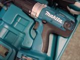 a cordless drill in a blue case with tools in it