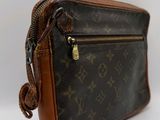 a close up of a brown and black purse on a white background
