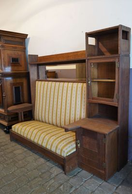 a couch that is next to a bookcase in a room