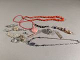 tout un tas de colliers et de bracelets différents posés sur la table