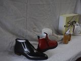 two pairs of shoes sitting on a table next to a box