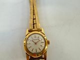 an image of a woman ' s wrist watch on a white surface