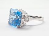 an image of a ring with a blue topaz stone and diamonds
