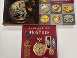 three books on a table with a clock and a book cover