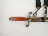 a picture of a knife with a red handle on a white surface