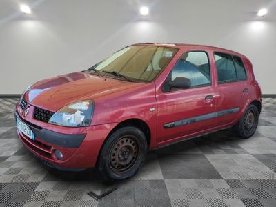 a picture of a small red car parked in a garage