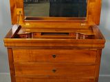 an old wooden dresser with a mirror on top of it