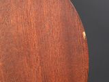 a close up of a wooden guitar with a black background