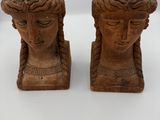 pair of carved wooden head sculptures of a woman and a man