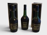 three bottles of wine sitting next to each other on a white surface