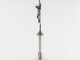 an antique silver plated candle holder with a cross on it