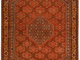an antique persian rug with a red and brown design