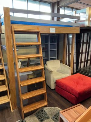 un lit mezzanine avec un pouf rouge au milieu de la pièce