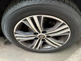 the tire of a car with a flat tire on the side of the road