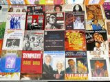 a lot of music cds and cds on the table