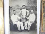 three men in uniform posing for a picture in front of a picture