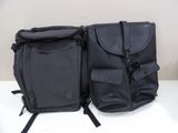 two bags that are sitting on a white table