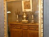 a mirror hanging on the wall above a dresser