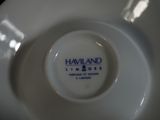 a white plate with a blue and white logo on it