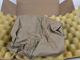 a cardboard box with a bag of potatoes inside of it