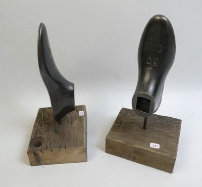 two pieces of art that are sitting on a wooden stand