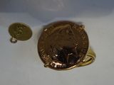 a penny and a coin sitting on a white surface