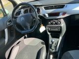 the interior of a small car with a steering wheel and dashboard