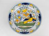 a plate with a bird and flowers on it