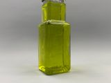 a bottle of olive oil on a white surface