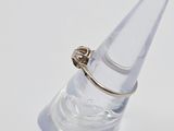 a ring that is sitting on top of a clear cone