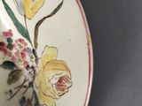 a plate with a flower design on it on a table