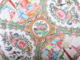 a plate with a picture of a garden scene on it