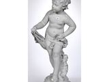 a white statue of a child holding a bird on a pedestal