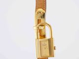 a close up of a gold watch with a padlock on it