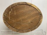 a wooden plate on a clear display case