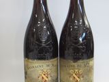 two bottles of wine sitting next to each other on a table