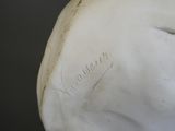 a close up of a statue of a person ' s head with writing on it