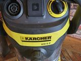 a close up of a yellow and black vacuum on a brick floor