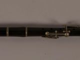 a black pen that is laying on a white surface