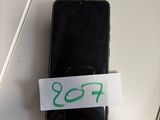 a cell phone with a sticker on it sitting on a table