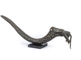 statue of a lizard on a black base on a white background