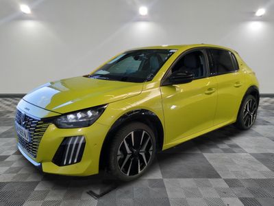 a yellow car is parked in a room with a checkered floor