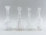 three clear glass vases sitting next to each other on a white surface