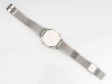 a close up of a watch on a white surface with a white background