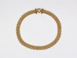a gold chain bracelet with a clasp on a white background