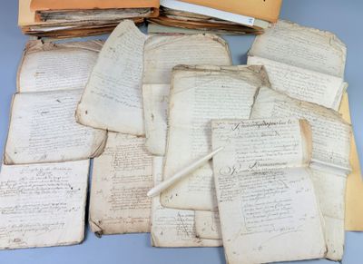 several old papers are stacked on top of each other on a table