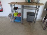 an image of a kitchen with a table and a trash can