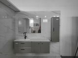 a large bathroom with a marble floor and white walls