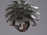 a metal light hanging from the ceiling in a room